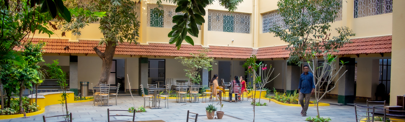 Green courtyard seating at Rani Meyyammai Hostel