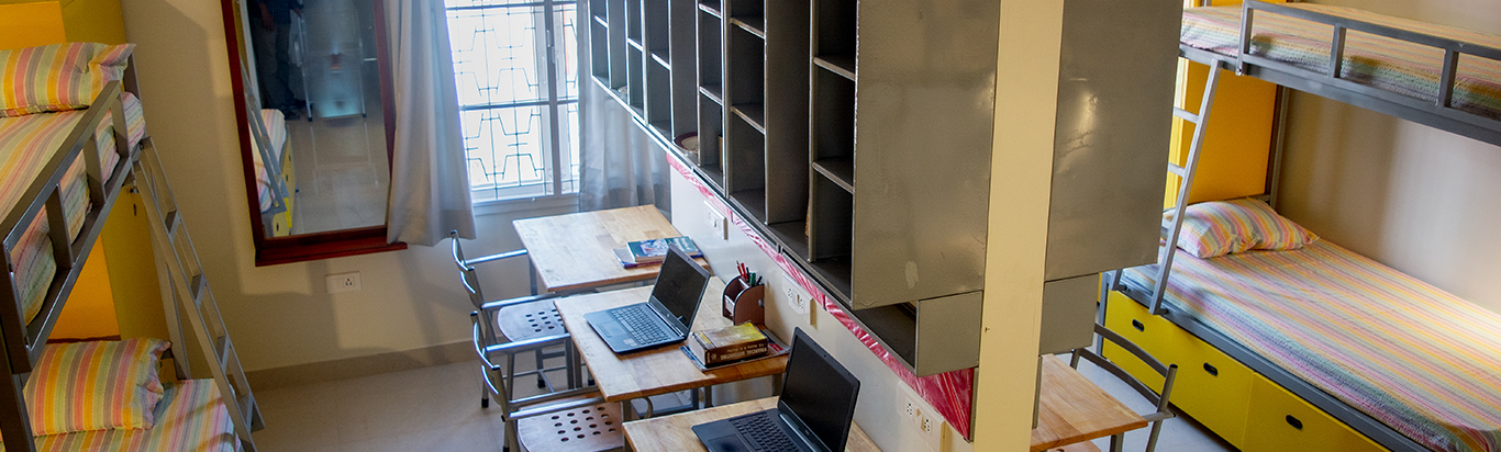 Hostel room with beds and study shelves in Chennai